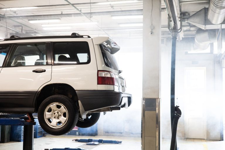 Car raised on a lift in a workshop